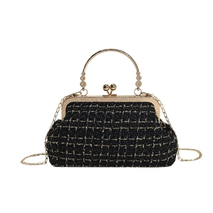 Elegant black and gold tweed shoulder bag with vintage metal handle and chain strap