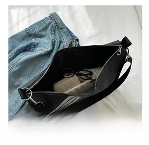 Interior view showing the large capacity of a black sports nylon bag with essentials