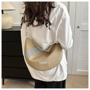 Beige crescent moon bag with reflective stripes and Fashion label worn as crossbody