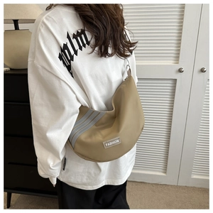 Back view of a khaki crescent nylon bag with grey stripes and Fashion logo label