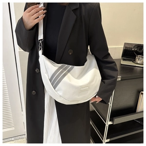 Detailed shot of white nylon crescent bag with grey stripes and adjustable strap