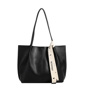 Minimalist black faux leather tote bag with stylish cream fashion ribbon and long handles