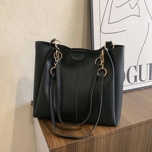 Classic black leather tote bag with gold chain rings and spacious commuter design