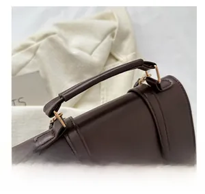 Detailed close-up of comfortable dark brown leather handle and cute bear embroidery
