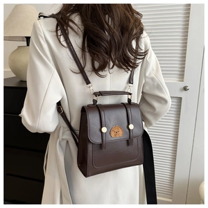 Brown vintage PU leather backpack with cute dog embroidery shown on model back
