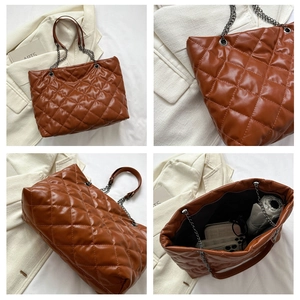 Detail of dark brown quilted tote bag showing leather texture and chain strap