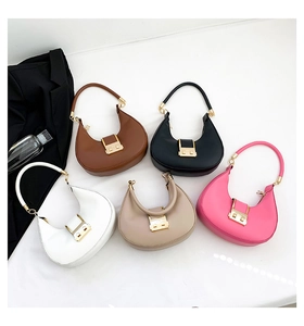 Detailed flat lay of semi-circle handbags in five colors with golden metallic buckles