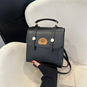 Minimalist black PU leather backpack with a cute cartoon dog patch for daily commute