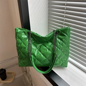 Green quilted tote bag with chain strap and diamond stitch pattern for women