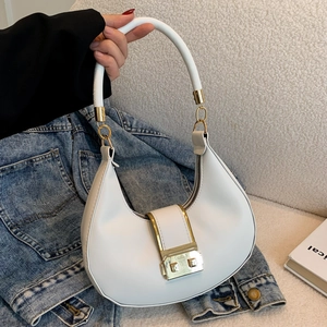 Minimalist white leather hobo bag with gold metal buckle on a casual denim background