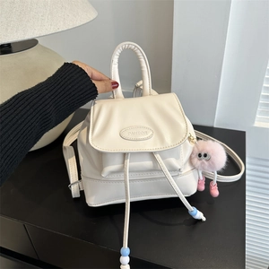 Chic cream PU leather mini backpack with drawstring closure and pink pom-pom charm
