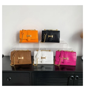 Detailed close-up of colorful crocodile embossed leather bags with golden H-buckle