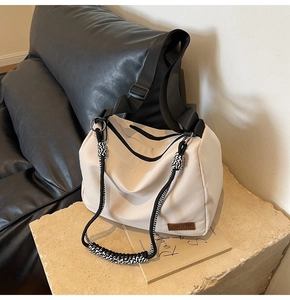 Detail of cream nylon tote bag with braided rope accents and JINGPIN leather label