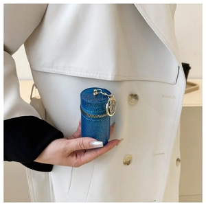 Close-up of glitter cylinder mini chain bag with gold metal clasp and zipper detail