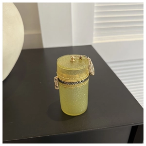 Cylindrical yellow glitter mini pouch with black zipper and metallic keychain clip