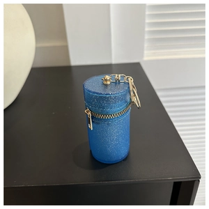 Close-up of blue glitter mini bag with gold zipper and keychain clip detail