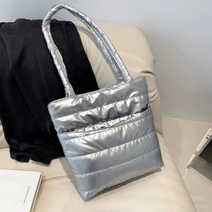 Silver quilted space cotton puffer tote bag with a metallic finish and wide shoulder strap