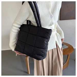 Vista dettagliata della borsa tote trapuntata nera sulla modella per stile quotidiano