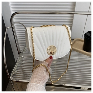 Detail of white chain shoulder bag with radial stitching and golden shell clasp