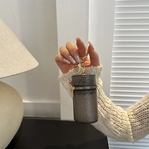 Mini gray glitter cylinder crossbody bag with golden chain and keyring attachment