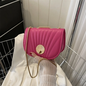 Minimalist fuchsia crossbody saddle bag with shell quilting and gold chain strap