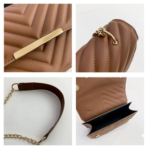 Detail view of brown V-quilted crossbody bag showing metal lock and double compartments