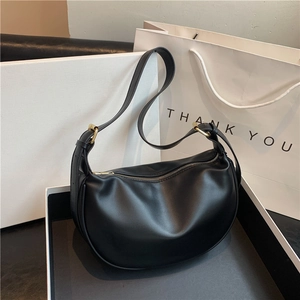 Minimalist black leather hobo bag with gold hardware and adjustable strap for women