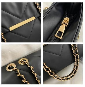 Detail of black quilted shoulder bag with gold hardware, chain strap and zipper close-up