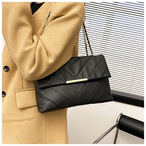 Classic black quilted shoulder bag with V-shaped stitching and gold chain strap detail