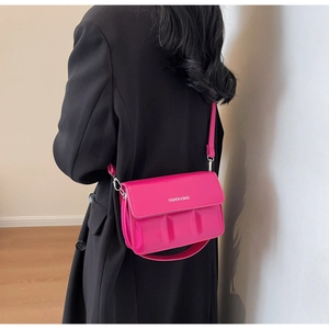Detail of flamingo red crossbody bag with embossed texture and Fashion & Bags text