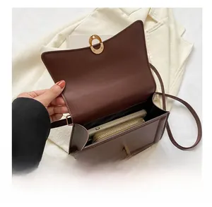 Interior view of brown flap crossbody bag showing capacity for phone and wallet