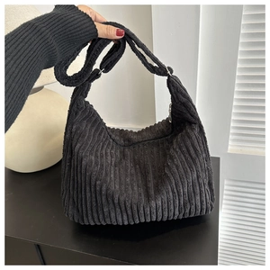 Détail du sac hobo en velours côtelé noir avec texture côtelée et bandoulière
