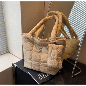 Detail of khaki quilted tote bag with matching zipper pouch and textured finish
