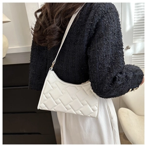 Detail of white quilted geometric woven shoulder bag with fine strap and gold hardware