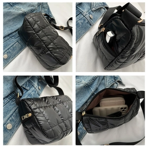 Detail view of black quilted bubble bag with adjustable strap and spacious interior