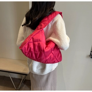 Détail du sac cabas en nylon matelassé rose vif avec une grande capacité et texture souple
