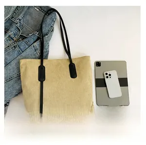 Detailed top view of beige corduroy tote bag showing large capacity for tablets and phones