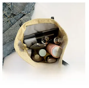 Interior view showing the large capacity of this corduroy tote bag with various daily items