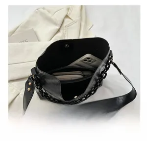 Interior view of black pleated tote bag showing large capacity for phone and wallet