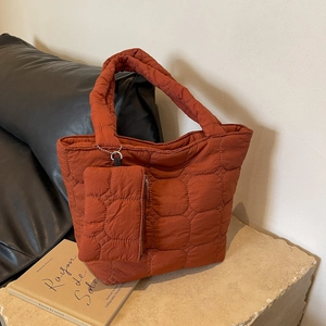 Quilted tote bag set in brick red nylon with matching small pouch and white stitching
