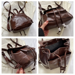 Detail view of brown vintage leather backpack showing interior lining and compartments