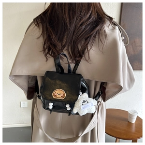 Mini black leather backpack featuring cute dog embroidery and white plush star accessory