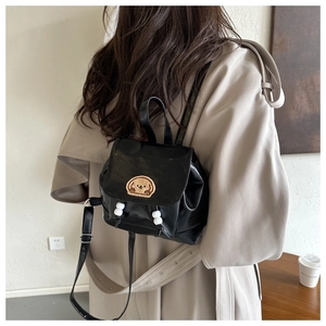 Rear view of a black PU leather mini backpack with dog embroidery and beaded detail
