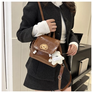 Brown vintage PU leather mini backpack with cartoon patch and white bear charm detail