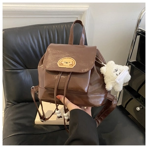 Brown faux leather backpack with cute dog patch and white star plush charm detail