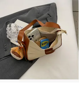 Interior view showing spacious capacity of canvas and brown leather bucket bag