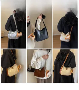 Chic half-moon hobo bag with teddy bear charm shown in various colors and carrying styles