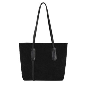 Minimalist black corduroy tote bag with leather straps on a white background
