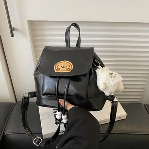Black leather mini backpack with dog embroidery and cute plush keychain accessory