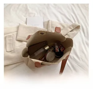 Interior view of beige tote bag showing large capacity for phone and cosmetics
